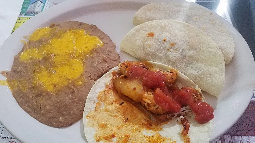 Spicy Chicken Taco in a Soft Corn Tortillas with a Side of Beans